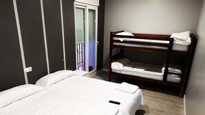 A bedroom with a single bed, a bunk bed, and a window with blinds. - Pensión La Bilbaina - Albergue Logroño (Logroño)