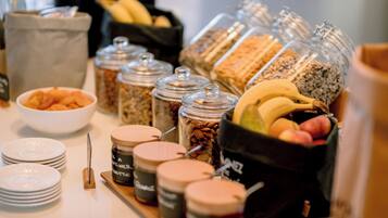 A breakfast buffet with various food items and condiments.