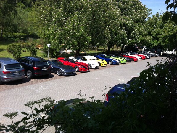 A parking lot with various cars parked in rows.