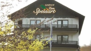 A two-story building with a sign reading "GASTHOF Zum Spessart."