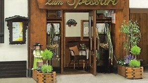 A building with a sign reading "Zum Spessart" and a wooden facade.