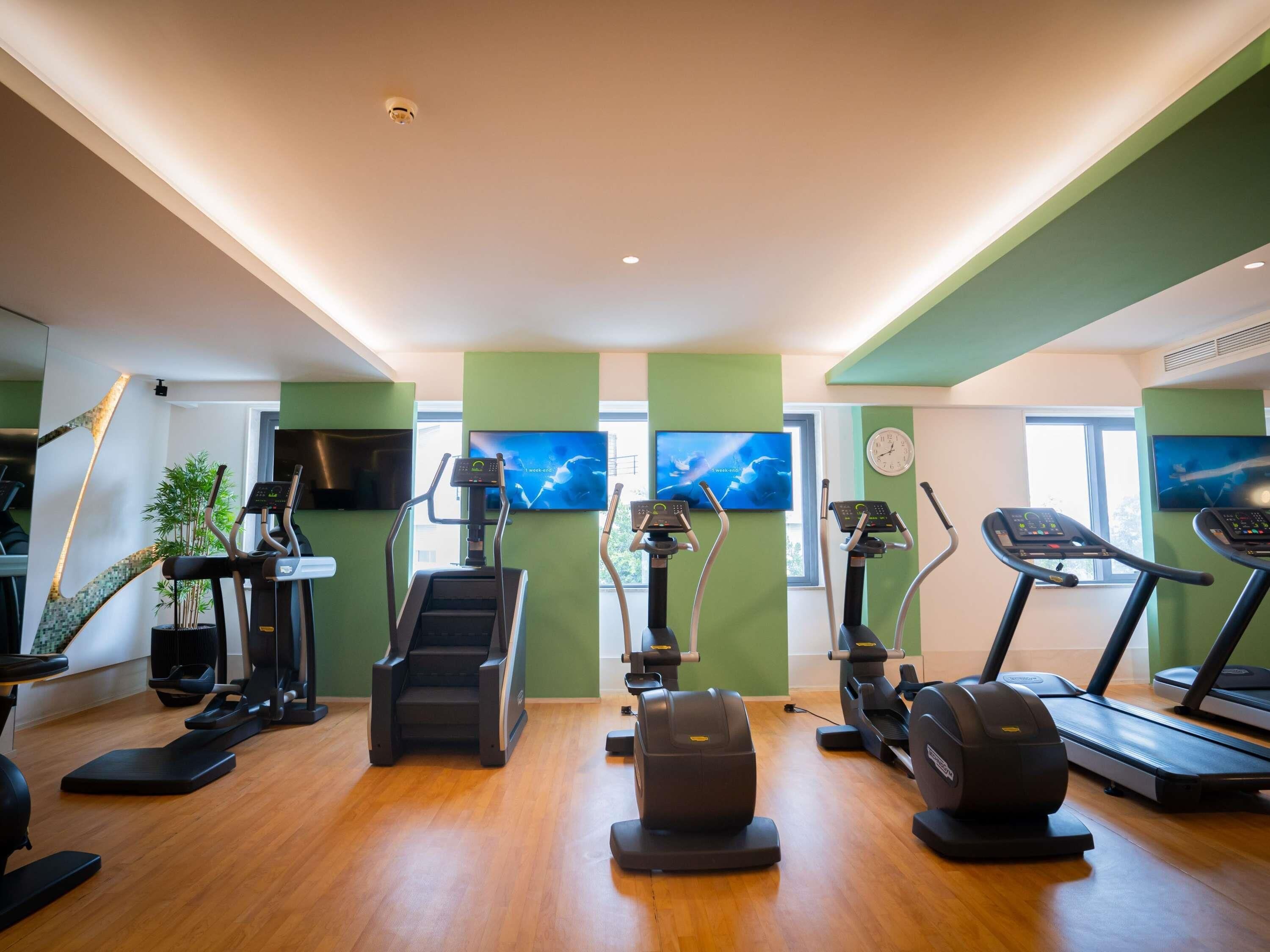 A gym with treadmills, elliptical machines, and a stair climber.
