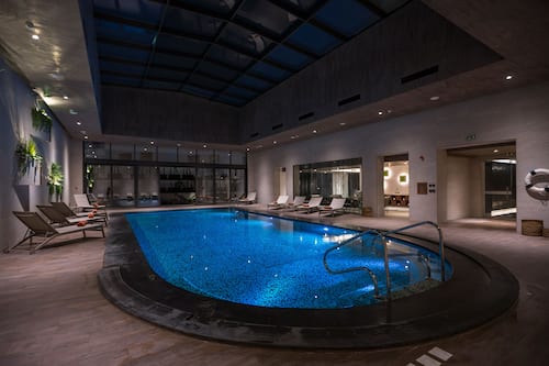 Indoor pool, open 6:00 AM to 10:00 PM, pool loungers
