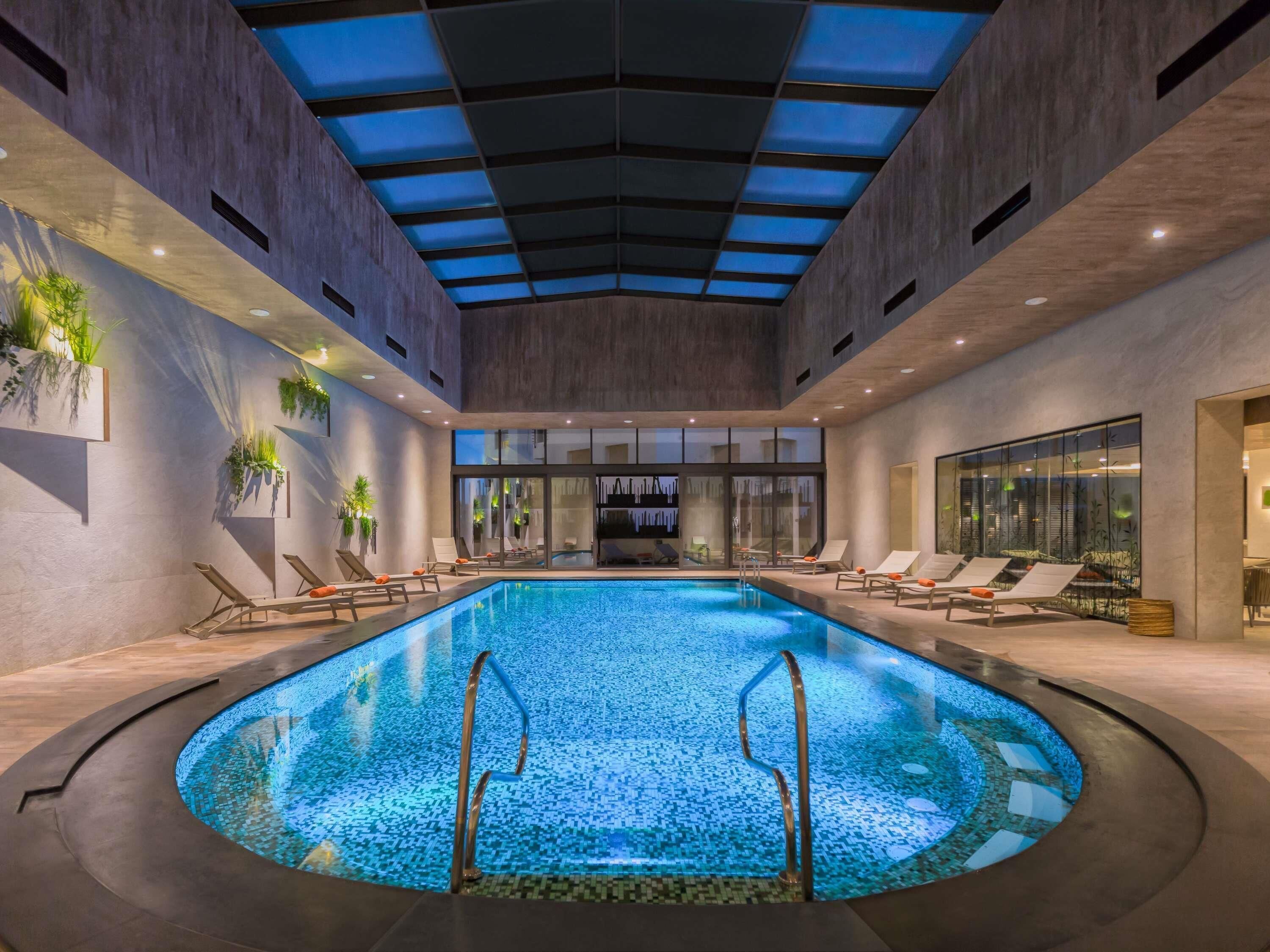 Indoor pool, open 6:00 AM to 10:00 PM, pool loungers