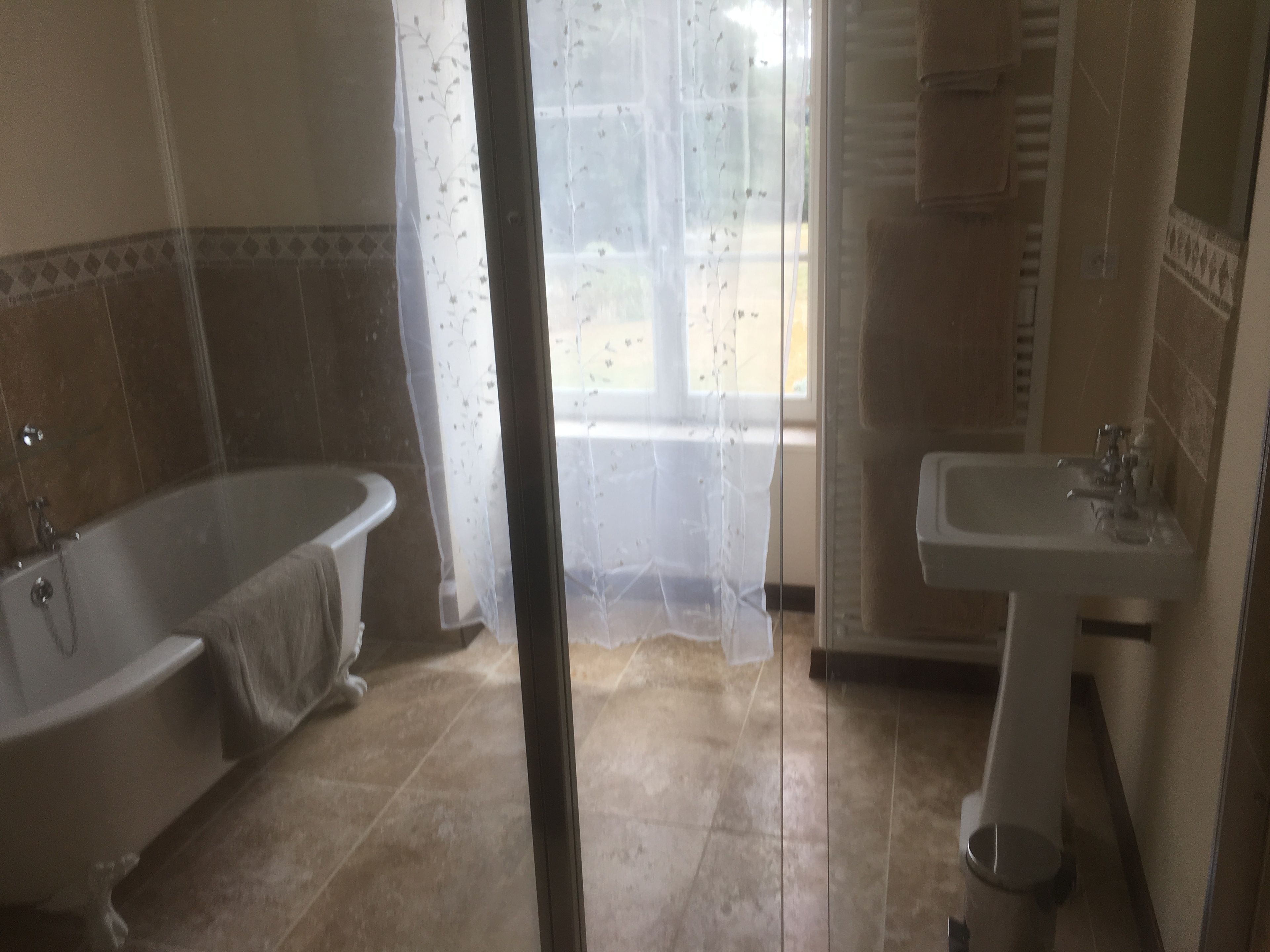 A bathroom with a bathtub, a sink, and a shower.