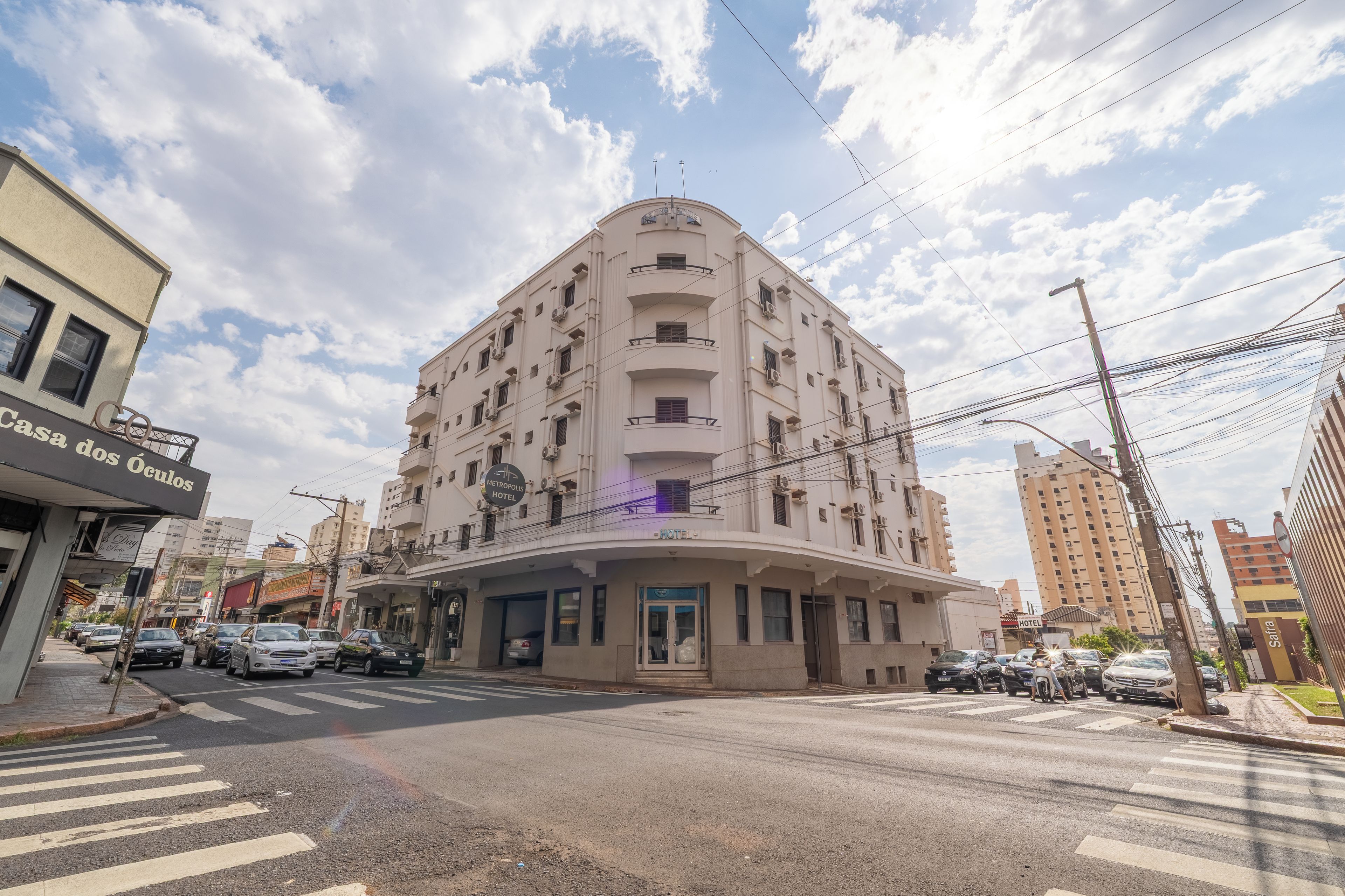 A multi-story hotel with a curved facade, multiple balconies, and a visible entrance.