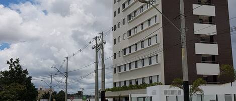 A multi-story hotel with a prominent 'Ibis Styles' sign, featuring a modern design with balconies and a flat facade.