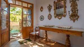 A room with a wooden door leading to a garden, a wooden chair, a table with a tray, and several wall-mounted mirrors. - CA NA CARME (CA NA CARME ALARONERA) - Chalet for 4 people in Alaro. Free WiFi (Alaró)