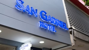The exterior of the San Gabriel Hotel with its name illuminated in blue letters. - Hotel San Gabriel (Barrancabermeja)