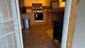 A kitchen with a stove, sink, and cabinets. - Wild Horse Guesthouse, Downtown Durango (Durango)