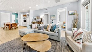 A spacious living area with a sofa, coffee table, and dining set. - Come stay with us at the Golden Hour! Spacious and relaxing 2 bed/2 bath cond (Port Aransas)