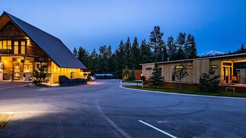 A lodge with a prominent wooden structure, a visible ice cream shop, and a well-lit entrance.