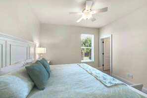 A bedroom with a bed, a ceiling fan, a window, and a door. - ☀️Community Pool-PRIME 30A Location-Topsail Village 422☀️ (Santa Rosa Beach)
