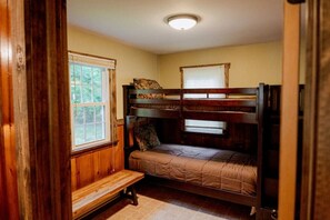 A bunk bed room with a window, wooden walls, and a bench. - Salmon Creek Cabin - Allegheny National Forest (Marienville)