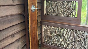 A wooden cabin with a door, a window, and a wooden railing. - Enjoy 'Treetops' in the North Ga Mountains.  Now with Wifi! (Rabun Gap)