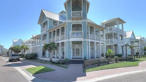 A large, multi-story building with a prominent tower and multiple balconies.