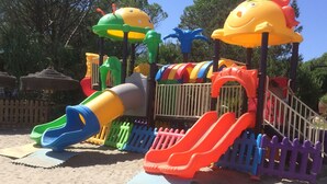 A colorful playground with slides and climbing structures. - Charming apartment on the mountainside near the sea (Villaputzu)