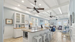 A spacious kitchen with a central island, white cabinetry, and a ceiling fan. - Beautiful, 3rd-Fl, Pet-Friendly Condo@Cinnamon Shore w/ Easy Amenity Access! (Port Aransas)