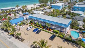 A resort with a pool, multiple guest rooms, and a view of the ocean. - Steps to the Shore–Beach Club at AMI 14 Resort-RVA (Bradenton Beach)