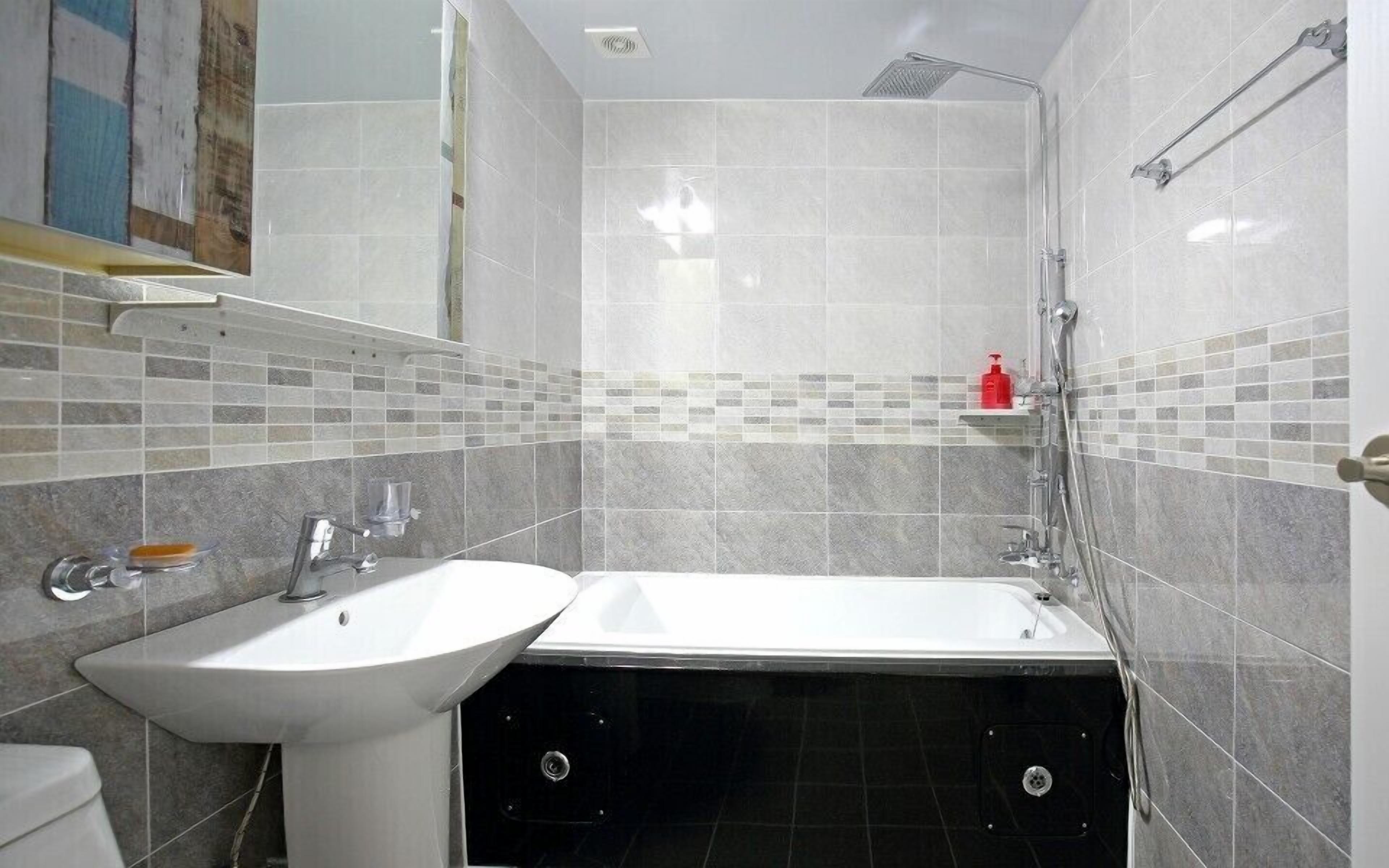 A bathroom with a sink, a bathtub, and a shower.