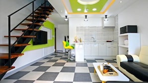 A modern living space with a staircase, a kitchen area, and a seating area. - Gyeongju The one Pension - Blue (Gyeongju)