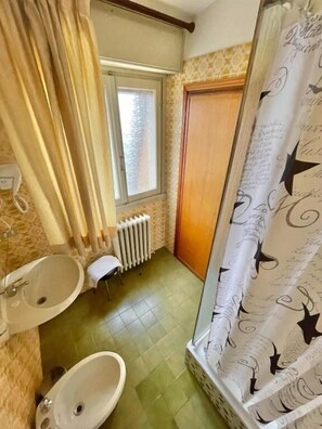 A bathroom with a shower, two sinks, a radiator, and a window. - Hotel La Sorgente (Plesio)