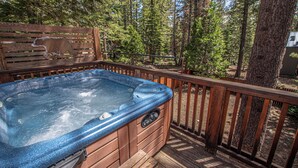 A hot tub on a wooden deck surrounded by trees. - Sherman by Hauserman Rentals (Tahoma)