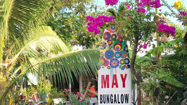 A colorful sign for May Bungalow with a bicycle decorated with bottle caps. - May Bungalow (Mui Ne)