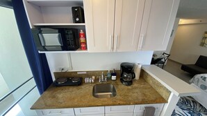A compact kitchenette with a microwave, coffee maker, and a small sink. - Aloha Suite Near the Sea II, 3 Block Walk to Beach (Honolulu)