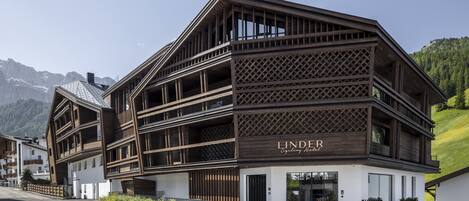 A modern building with a check-in desk and a sign reading "LINDER Cycling Resort".