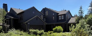 A dark wooden house with multiple gabled roofs and a garage. - Snowcreek Resort Vacation Rental 1152 (Mammoth Lakes)