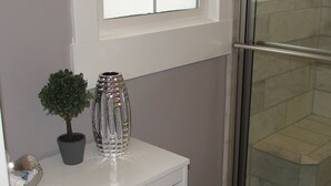 A bathroom with a white vanity, a potted plant, and a decorative vase. - !!NEW!! Luxurious remodeled home !! No cleaning fee! (Idaho Falls)