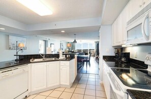 Enjoy meals in this well-equipped kitchen with a large island, oven, and dining area.