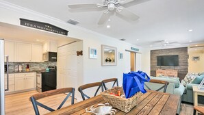 A modern kitchen with white cabinets, a microwave, and a ceiling fan. - Blue Pearl for 10-Heated Pool-Beach-Pier 5 minutes (Pompano Beach)