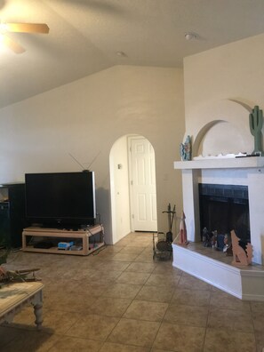 Living room with TV and fireplace.