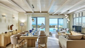 A spacious living area with a dining table, chairs, a sofa, and a TV. - Villa Greece Privat Seaview Villa with private heatable Pool  (Hersonissos)