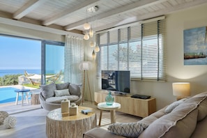 open living room area with direct pool and seaview