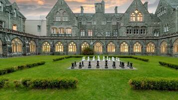 A historic building with a courtyard featuring a chessboard.