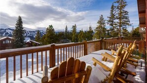 A wooden deck with snow-covered chairs and a view of snow-capped mountains. - Emmett's Overlook (Breckenridge)