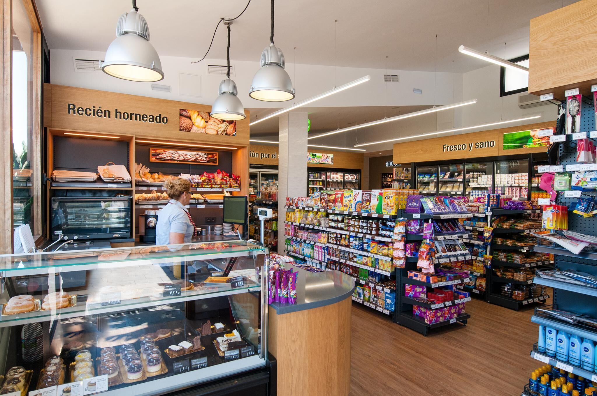 A bakery section with a display of baked goods and a refrigerated section with fresh produce.