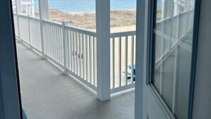A covered porch with a view of the beach and ocean. - Oceanfront condos with rare 2 night minimum rentals and linens included! (Ocean City)