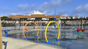 A water play area with colorful structures and a building in the background. - Elevated Ground Floor Apartment, 3 Rooms, 6 Sleeps, Pool, Terrace, Parking, Sports Facilities (Port Barcarès)