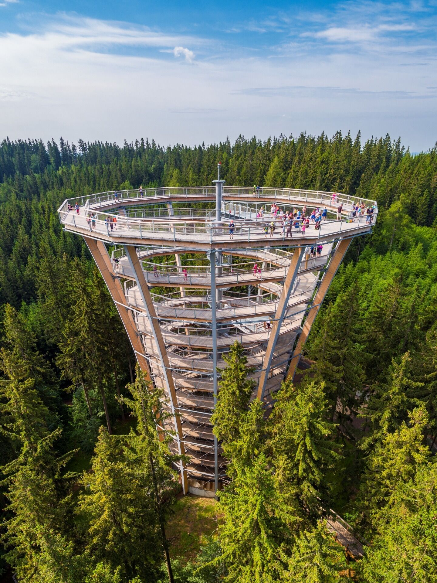 A multi-level observation tower surrounded by dense forest.