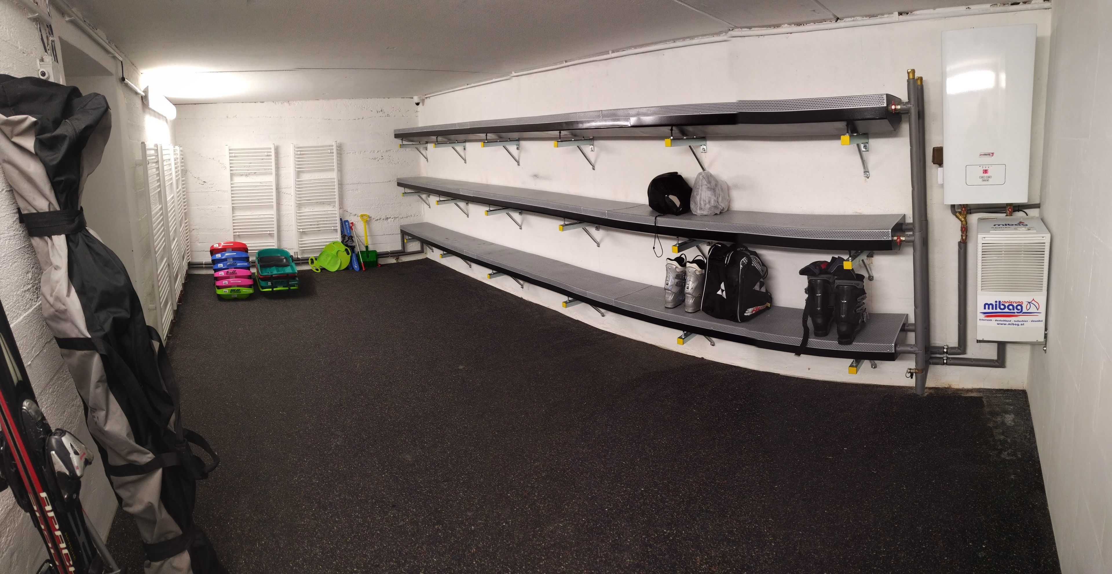 A storage area with shelves for equipment, a water heater, and a radiator.