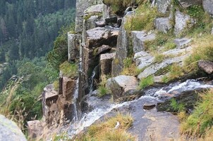 Un acantilado escarpado con una cascada.