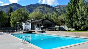 A swimming pool with a view of mountains in the background.