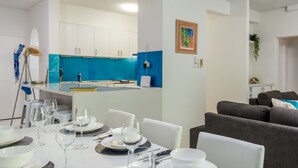 A modern living room with a dining area. - Tranquility Chill at Palm Cove (Palm Cove)