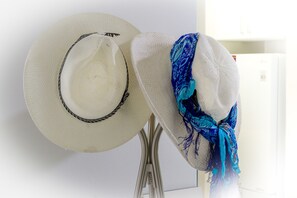 Two hats on a stand.