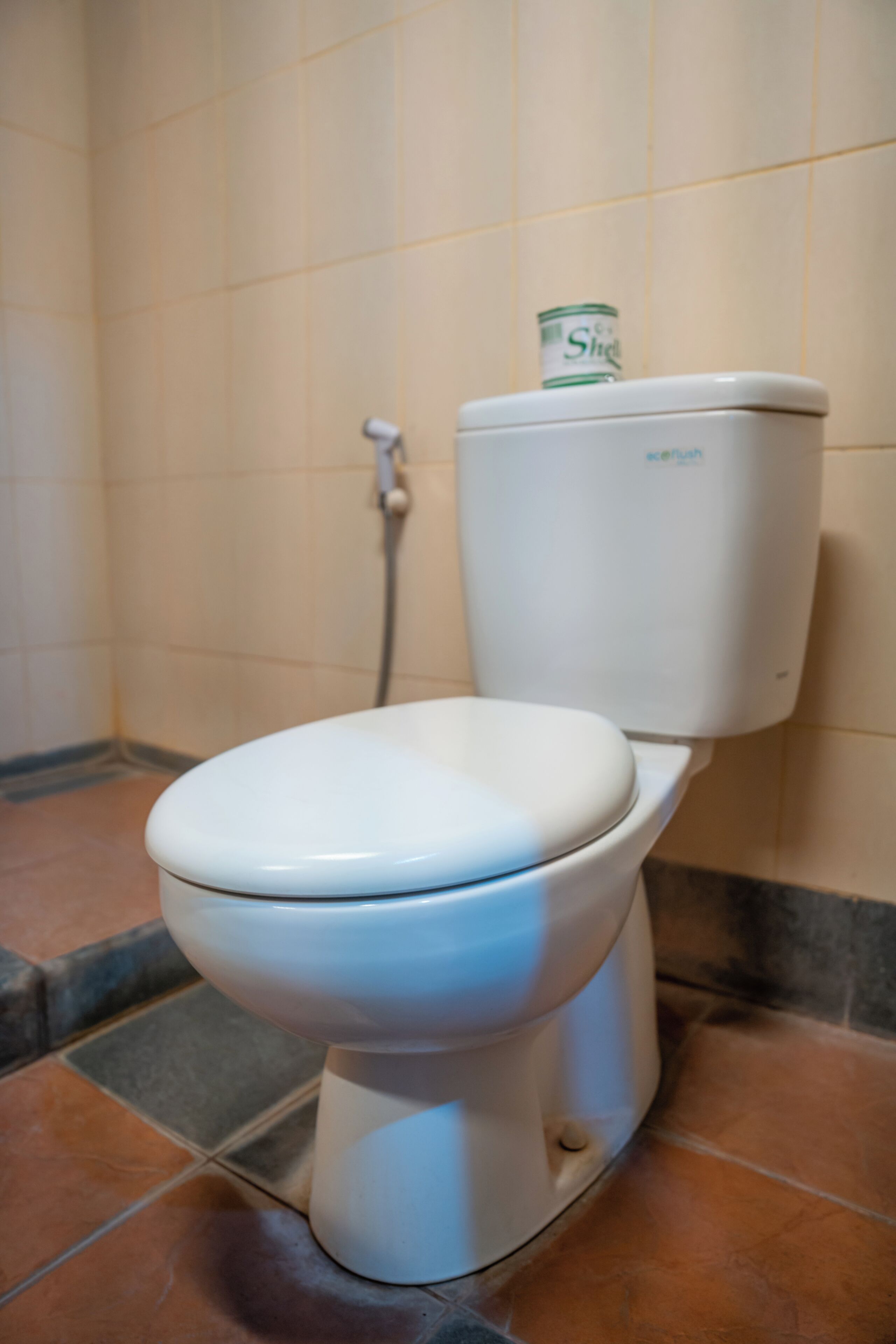 A white toilet with a tank that has a label.