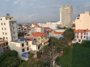 Zona residencial com diversos edifícios, incluindo um prédio de apartamentos alto e casas menores com telhados vermelhos.